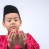 cute-boy-wearing-maroon-traditional-clothing-standing-against-white-background_1048944-20545647