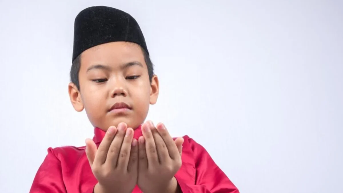 cute-boy-wearing-maroon-traditional-clothing-standing-against-white-background_1048944-20545647