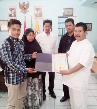 BEBAS TUNGGAKAN: Kepsek SMKN 6 Bandung Ramdan, menyerahkan ijazah asli milik Taofik Hamdani kemarin (24/7).