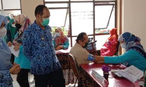 Pelaksanaan Tugas (Plt.) Wali Kota Cimahi, Ngatiyana memantau warga lansia sedang disuntik vaksin dalam acara gebyar vaksinasi lansia, di Kantor Kecamatan Cimahi Tengah, belum lama ini. (Intan Aida/Jabar Ekspres)