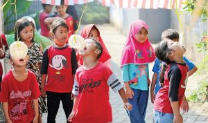 Sejumlah anak berpartisipasi dalam lomba makan kerupuk yang diselenggarakan oleh dan untuk kalangan keluarga sendiri di Bekasi. (IMAM HUSEIN/JAWA POS)