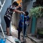 Seorang petugas DPKP Depok saat mengevakuasi seekor ular. (ist)
