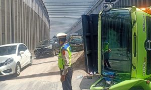 Anggota polisi tengah mengatur arus lalu lintas setelah sebuah truk mengalami kecelakaan di Nagreg.