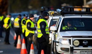 Australia Catat Rekor Kematian Tertinggi Selama Pandemi Covid-19 Arsip - Petugas kepolisian NSW berbicara kepada pengemudi yang akan menyeberang dari Negara Bagian Victoria ke New South Wales (NSW) di pos pemeriksaan perbatasan, yang ditutup karena lonjakan kasus penyakit virus corona (COVID-19), di Albury, New South Wales, Australia, Rabu (8/7/2020). (ANTARA FOTO/AAP Image/Lukas Coch via REUTERS/AWW/djo)