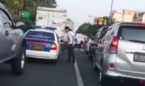 Viral! Pria Berambut Panjang Nekad Masukkan Sampah ke Mobil Polisi Saat Macet Video viral, pria berambut panjang masukkan sampah ke mobil polisi. (tangkapan layar)