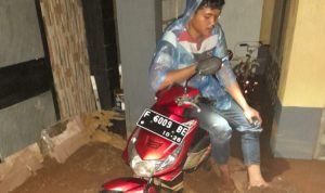 Salah satu motor warga yang terkubur dalam lumpur akibat banjir yang melanda di Bogor. (Foto:Yudha Prananda)