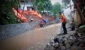 Petugas BPBD Kota Bogor saat meninjau salah satu lokasi yang dilanda longsor. (Yudha Prananda / Istimewa)