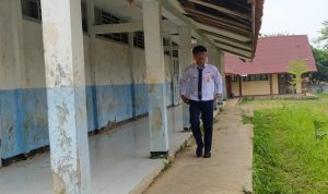 LEWATI RUANG SEKOLAH: Seorang siswa di SMPN 1 Cipongkor saat melintas di area bangunan yang hampir roboh. (Foto: Akmal Firmansyah/Jabarekspres)