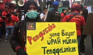 Sambut May Day 2023, Puluhan Ribu Buruh Siap Turun Bawa 6 Tuntutan Ini SAMPAIKAN ASPIRASI: Seorang buruh membentangkan kenaikan UMK Jabar saat demonstrasi di Gedung Sate, Kota Bandung beberapa pekan lalu.