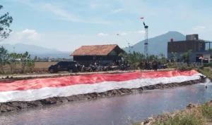 Passer kibarkan kain merah putih sepanjang 78 meter di sungai Cikijing, Kecamatan Rancaekek, Kabupaten Bandung. Jabar Ekspres/Yanuar Baswata.
