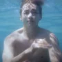Tangkapan layar MV Slow Dancing - V BTS yang menampilkan adegan V Berenang tanpa baju. (Youtube)