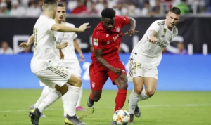 Alphonso Davies (baju merah) kala melawan Real Madrid di ICC 2019.