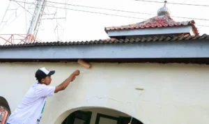 Sukarelawan Santri Dukung Ganjar (SDG) melakukan aksi pengecatan musala di Desa Mekarjaya, Kecamatan Purwasari, Karawang, Jawa Barat.