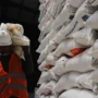 Harga Beras Naik: Pekerja memikul beberapa karung beras di Gudang Bulog, Gedebage, Kota Bandung.