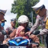Kepala Satlantas Polresta Bogor Kota, Kompol Galih Apria bersama jajaran saat membagikan Sabuk Keselamatan kepada pengendara motor yang membawa anak-anak di Simpang Semplak, Kecamatan Bogor Barat, Kota Bogor.