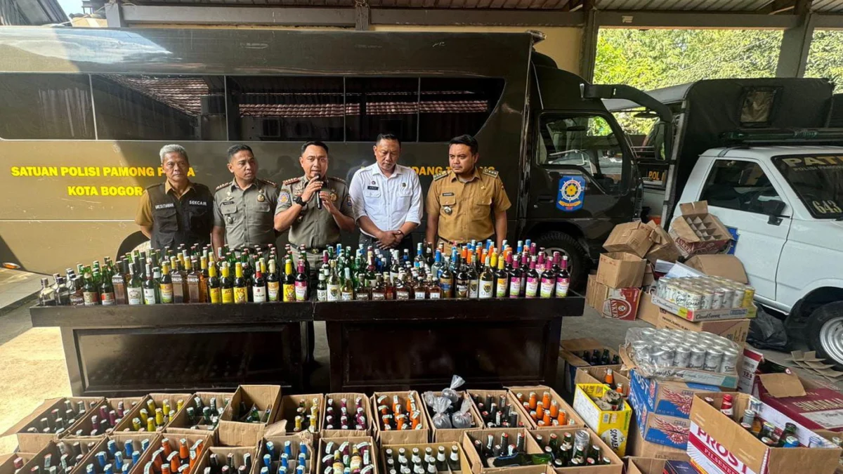 Satpol PP Tindak Tegas Penjual Minuman Keras di Kota Bogor, Ribuan Botol Dimusnahkan Satpol PP Kota Bogor saat melakukan pemusnahan ribuan botol miras beragam jenis, Senin (8/7). (Yudha Prananda / Jabar Ekspres)