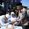 Penjabat Gubernur Jawa Barat Bey Machmudin menjadi saksi nikah pada kegiatan nikah massal dalam rangkaian West Java Festival 2024 di kawasan Gedung Sate, Kota Bandung, Sabtu (24/8/2024).(Foto: Rizal FS/Biro Adpim Jabar)