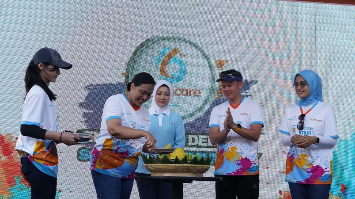 Direktur Medis & Hubungan Kelembagaan Bio Farma, Sri Harsi Teteki beserta Ketua Forum Jawa Barat Sehat, Atalia Praratya (tengah) di kegiatan pemotongan tumpeng pada acara Fun Run “Enam Tahun Dedikasi – Solution to Immunity” HUT Immunicare ke – 6