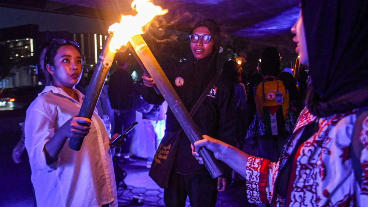 Massa yang tergabung dalam Aliansi Simpul Pembebasan Perempuan (Simpul Puan) melakukan aksi menyalakan obor saat peringatan Hari Perempuan Sedunia 2025 di Kota Bandung, Sabtu (8/3). Foto: Dimas Rachmatsyah / Jabar Ekspres