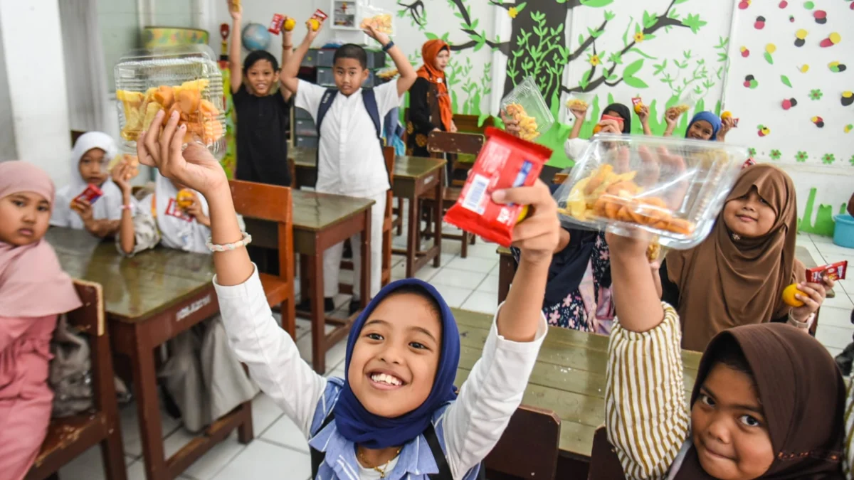 Sejumlah pelajar menunjukkan menu program Makan Bergizi Gratis (MBG) di bulan ramadhan yang mengalami penyesuaian di SDN 257 Pelita, Jalan Rajamantri Kidul, Kota Bandung, beberapa waktu lalu. Foto: Dimas Rachmatsyah / Jabar Ekspres