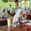 Sisiwa di SMA Negeri 1 Ciamis menyantap makanan dari program Makan Bergizi Gratis (MBG), Senin (14/4/2025). (Cecep Herdi/Jabar Ekspres)