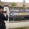 Seorang jurnalis memotret spanduk SAVESMANSABANDUNG di depan SMAN 1, Kota Bandung, Jum'at (25/4). Foto: Dimas Rachmatsyah / Jabar Ekspres