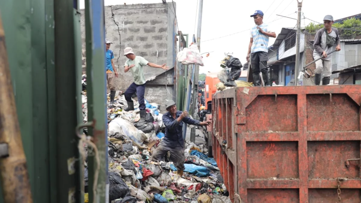 Para Petugas Sampah saat Membersihkan Tempat Pembuangan Sampah Sementara (TPST) (mong)