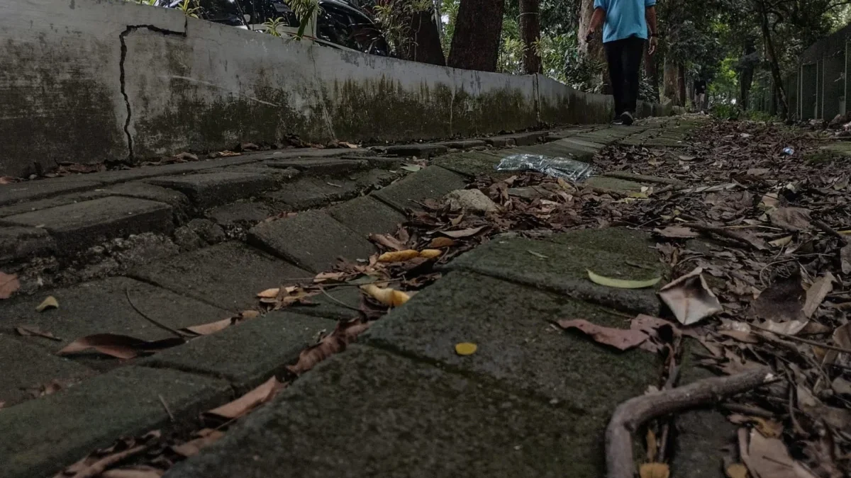 Warga berjalan di trotoar yang tidak terawat dan rusak di jalan Sumatera, Kota Bandung, Jumat (30/5). Foto: Dimas Rachmatsyah / Jabar Ekspres