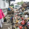 Pembeli melintas di samping tumpukan sampah di TPS Pasar Kosambi, Kota Bandung, Sabtu (21/6). Foto: Dimas Rachmatsyah / Jabar Ekspres