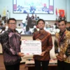 Wakil Direktur Utama Telkom Muhammad Awaluddin saat menerima cinderamata dari perwakilan mahasiswa UGM pada acara MBA Catalyst Summit 2025 di Universitas Gadjah Mada (UGM), pada Sabtu (5/7).
