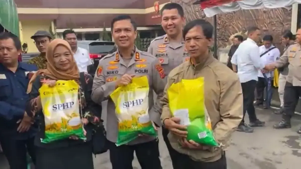 Kapolres Cimahi, AKBP Niko N. Adi Putra saat menyerah Beras Sphp pada Warga (mong)