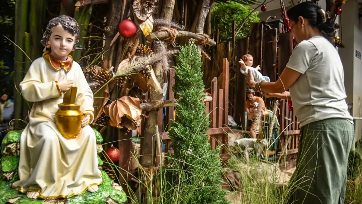 Petugas Gereja menata patung bayi Yesus dalam kandang domba saat persiapan jelang Natal di Gereja Katedral San