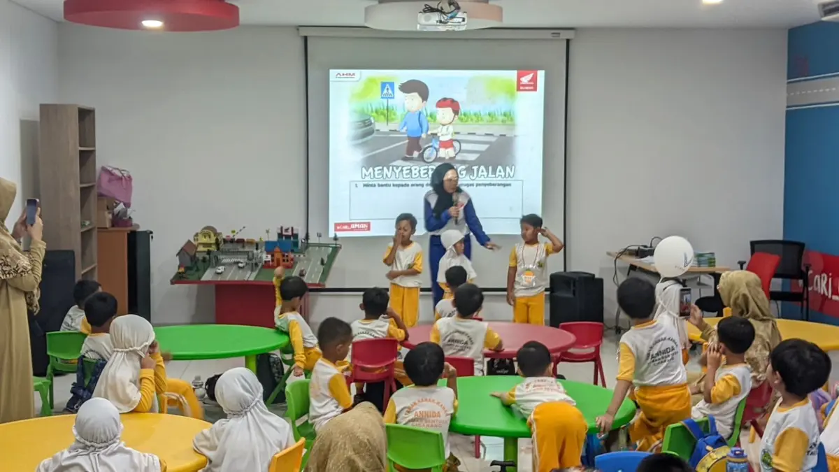 Para instruktur Safety Riding Astra Honda sedang memberikan edukasi kepada anak-anak usia dini dengan mengguna