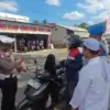 Aris, pengendara saat diberi apresiasi berupa teh manis karena berkendara dengan dilengkapi surat kendaraan be