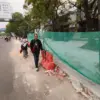 Warga berjalan di samping proyek trotoar di Jalan Ibrahiem Adjie, Kota Bandung, Selasa (1/9/2026). Foto: Dimas