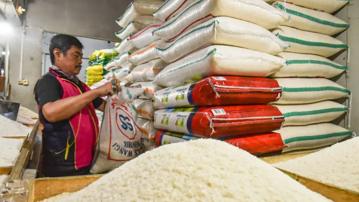 Pedagang mengemas karung berisi beras di Pasar Kosambi, Kota Bandung, Selasa (1/9/2026). Foto: Dimas Rachmatsy