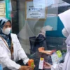 PELAYANAN: Apoteker Ai Istiklaliah, S.Farm, Apt, selaku Kepala Apotek Jasa Kartini saat menyerahkan obat langsung kepada Pasien.CINDY DESITA/PASUNDAN EKSPRES