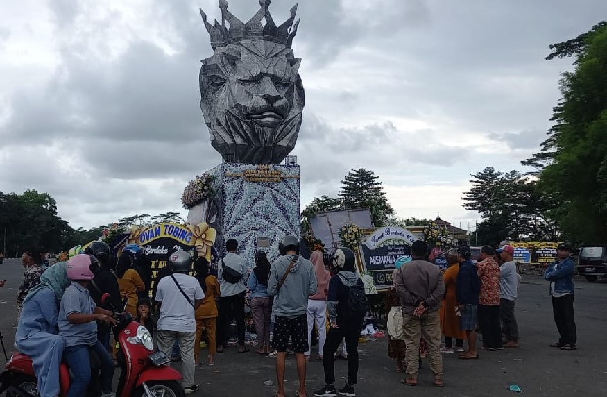 Catatan Harian Dahlan Iskan: Hidup Fanatisme (Tugu Singa Tangguh di Stadion Kanjuruhan Malang yang didatangi banyak orang untuk tabur bunga menyampaikan duka dan berdoa untuk para suporter yang meninggal dunia dalam tragedi.--foto via Disway.id)