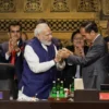 India's Prime Minister Narendra Modi (L) and Indonesia's President Joko Widodo take part in the handover ceremony during the G20 Summit in Nusa Dua on the Indonesian resort island of Bali on November 16, 2022. (Photo by WILLY KURNIAWAN / POOL / AFP)