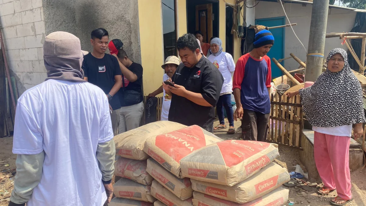 Yudha Puja Turnawan Anggota DPRD Garut menyumbang semen untuk pembangunan rumah Solihin di Desa Karyamukti Kecamatan Banyuresmi