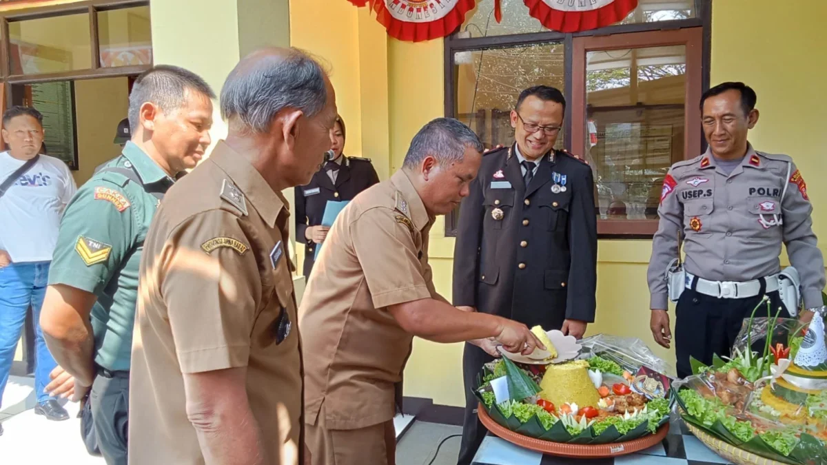 POTONG: Camat Cimanggung H. Agus Wahyudin saat memotong tumpeng pada perayaan HUT Bhayangkara ke -78 di Cimang