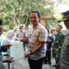 BERI BANTUAN: Kepala Desa Sindanggalih Eddy Setiawan saat memberikan sertifikat kepada salah satu warganya, ba