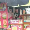 MANDIRI: Penjual Cilor Ari Ruslan saat berfoto bersama pembeli di tempat jualannya di Kecamatan Tanjungkerta,