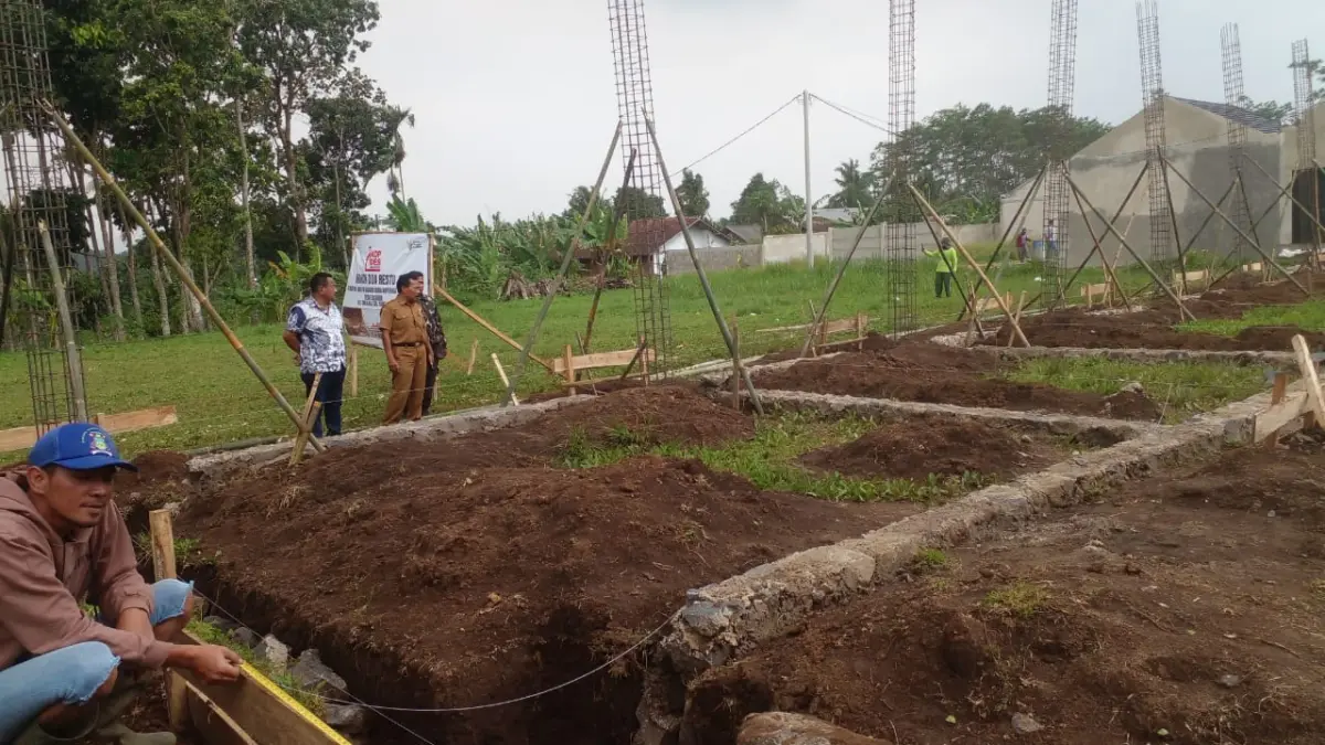 Caption : Kepala Desa Galudra, Sumpena BA., bersama Perangkat Desa saat meninjau pelaksanaan pembangunan KDMP